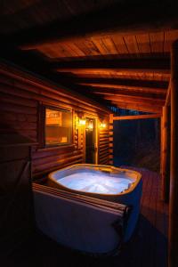 a large jacuzzi tub in a log cabin at Secluded Cozy Log Cabin Villa in Creola +32 photos