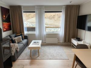 a living room with a couch and a table at Haugetuft Apartments in Åmot