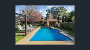 a swimming pool with chairs and a gazebo at La Dolce Vita in Ancona