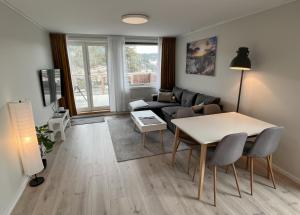 a living room with a table and a couch at Haugetuft Apartments in Åmot +53 photos