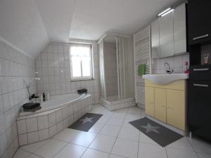 a white bathroom with a tub and a sink at behagliche Ferienwohnung in Elbingerode in Elbingerode +29 photos