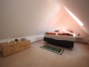 a bedroom with a bed and a dresser in a room at behagliche Ferienwohnung in Elbingerode in Elbingerode
