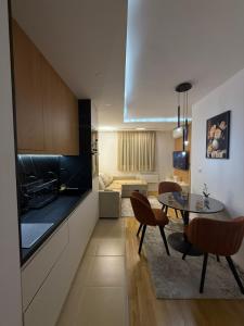 a kitchen and dining room with a table and chairs at Altura Garden 1 in Vrnjačka Banja