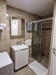 a bathroom with a shower and a sink and a mirror at Altura Garden 1 in Vrnjačka Banja +36 photos