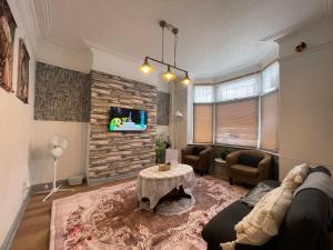 a living room with a couch and a table at Rose Cozy House in Stockton-on-Tees