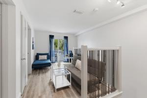 a living room with a couch and a table at Be A Nomad - 2BR Jacksonville Beach Apartment - 1 Min to Beach - Sleeps 4 in Jacksonville Beach