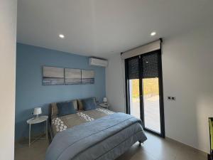 a bedroom with a bed and a large window at Vivienda en Granada, Cortijo Balcón Cotobro, Almuñécar, Casa con piscina y vistas increíbles in Granada +63 photos