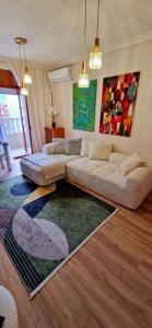 a living room with two couches and a rug at Apartament La Torre in Torrevieja
