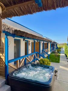 a hot tub on the side of a building at Delta Land Bungalows in Crisan