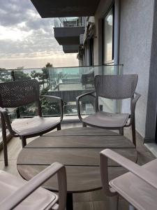 two chairs and a table on a balcony at Holiday apartaments Gaca in Lezhë