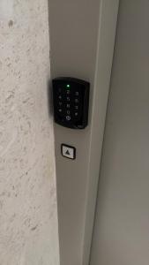 a remote control on the side of a wall at Holiday apartaments Gaca in Lezhë