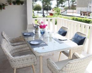 a dining table and chairs on a balcony at House PUNTA II in Umag