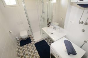 a white bathroom with a sink and a shower at House PUNTA II in Umag +32 photos