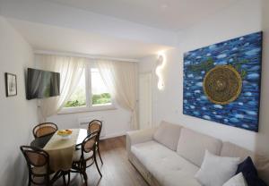 a living room with a white couch and a table at House PUNTA II in Umag