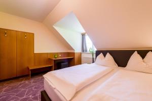 מיטה או מיטות בחדר ב-Gasthaus Wundsam