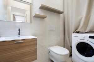 a bathroom with a toilet and a washing machine at Maison Carnot in Cannes