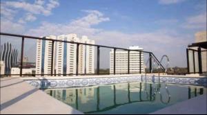 a large swimming pool with buildings in the background at Viel Comfort II in Asunción