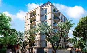 a white building with trees in front of it at Viel Comfort II in Asunción