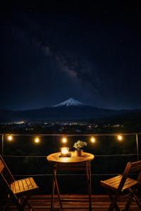a table on a balcony with a mountain in the background at Cabaña Con Impresionante Vista Volcan y Lago AYUN LAFQUEN in Villarrica