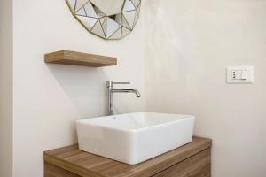 a bathroom with a white sink and a mirror at Maison Carnot in Cannes +5 photos