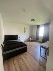 a bedroom with a bed and a chair in it at Wohnen Nähe Salzgittersee in Salzgitter +1 photo
