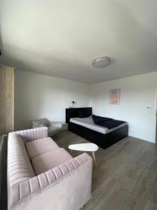 a living room with a couch and a bed at Wohnen Nähe Salzgittersee in Salzgitter