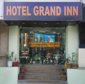 a hotel grand inn with a sign on the front of it at Hotel Grand Inn in Haridwār