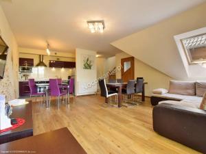 a living room with a couch and a table and chairs at Karpacz wczasy in Karpacz