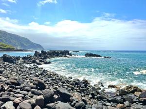 a rocky beach with the ocean and the sky at Ocean Whisper suite in Tacoronte