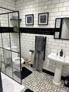 a bathroom with a toilet and a sink at STUNNING Apartments in Jarrow, next to A19 & Tyne Tunnel in East Howdon