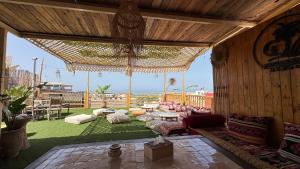 a large living room with a couch and a large ceiling at Natural Surf Morocco in Tamraght Ouzdar