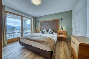 a bedroom with a large bed and a balcony at Gattererhof in Schenna +35 photos