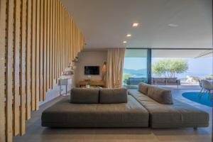a living room with a couch and a large window at Casa Lilia in Olmeto