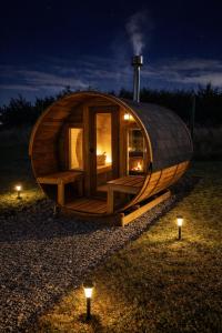 a round wooden cabin with lights in a field at night at Cabaña Con Impresionante Vista Volcan y Lago AYUN LAFQUEN in Villarrica +40 photos