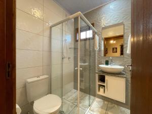 a bathroom with a toilet and a sink at Sentiero Lofts in Urubici +30 photos