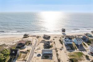 an aerial view of a beach with houses and the ocean at 7026 - Southwind in Rodanthe