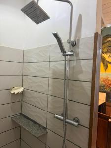 a shower in a bathroom with a glass door at Chez L'Avocatier in Sainte Marie +16 photos