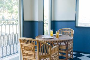 a table with two chairs and a table with drinks on it at 全室オーシャンビューの宿 ルーチェ須崎 in Shimoda +18 photos