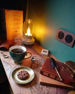 a table with a cup of coffee and a plate of food at La tiny house perdue in Saint-Blimont