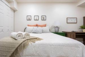 a bedroom with a large bed with towels on it at Cozy Country Guest Suite in Zionsville