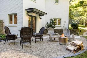 a group of chairs and a fire pit in front of a house at Cozy Country Guest Suite in Zionsville