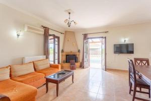 a living room with a couch and a table at Pothos Villas in Zakynthos