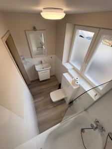 a bathroom with a sink and a toilet and a mirror at APARTEL Piaseczno in Piaseczno +98 photos