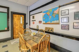 a dining room with a table and chairs and a map on the wall at Direct Warrior Trail Access! Ultimate ATV Getaway in Gary