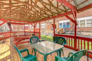 a patio with a table and chairs on a deck at Direct Warrior Trail Access! Ultimate ATV Getaway in Gary