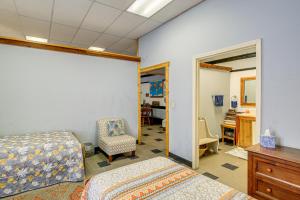 a bedroom with a bed and a chair and a desk at Direct Warrior Trail Access! Ultimate ATV Getaway in Gary +19 photos