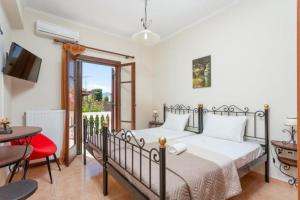 a bedroom with a bed and a table at Pothos Villas in Zakynthos +48 photos