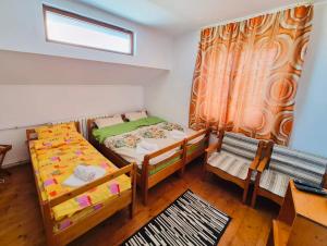 a bedroom with two bunk beds and a window at La Răscruce in Gărâna +7 photos