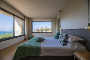 a bedroom with a bed with a large window at Casa Lilia in Olmeto +43 photos