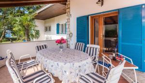 a table and chairs on the balcony of a house at House PUNTA UMAG in Umag +4 photos